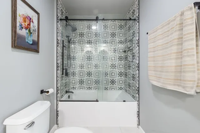 a bathroom with a bathtub and a toilet