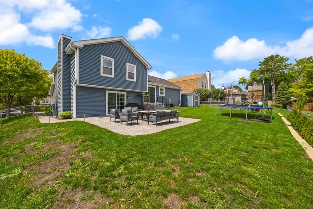 a front view of a house with patio and garden