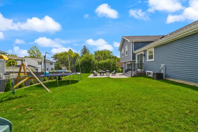 a view of a house with a backyard
