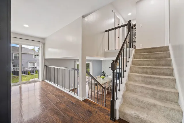 a view of staircase with wooden floor and a window