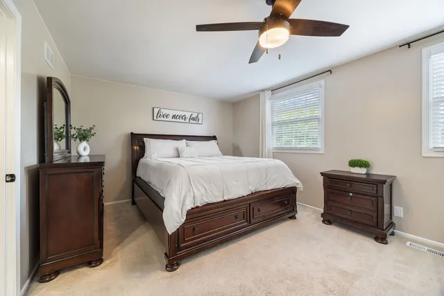 a bedroom with a bed dresser and a window