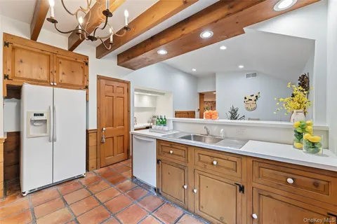 a view of a kitchen center island cabinets and stainless steel appliances