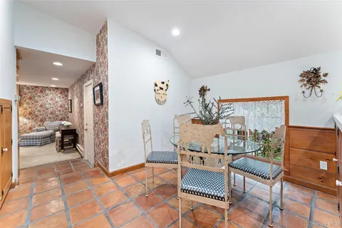 a living room with furniture and a painting on the wall