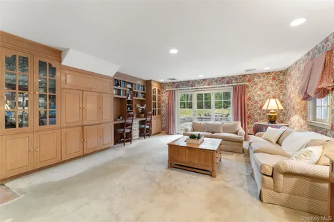 a living room with furniture cabinets and window
