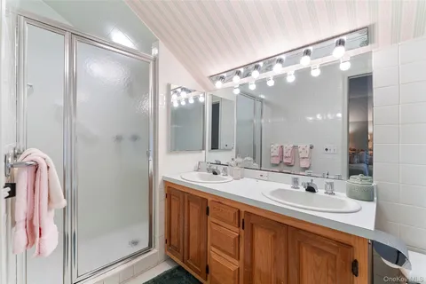a bathroom with a double vanity sink mirror and double