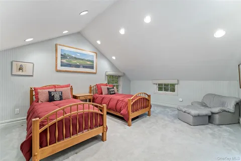 a bedroom with two beds and painting on the wall