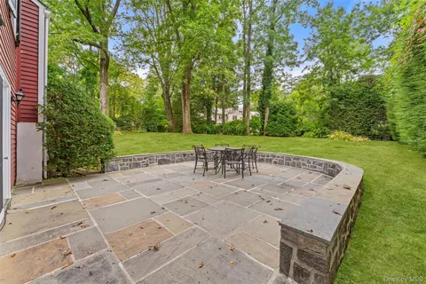 a view of a yard with a table and chairs