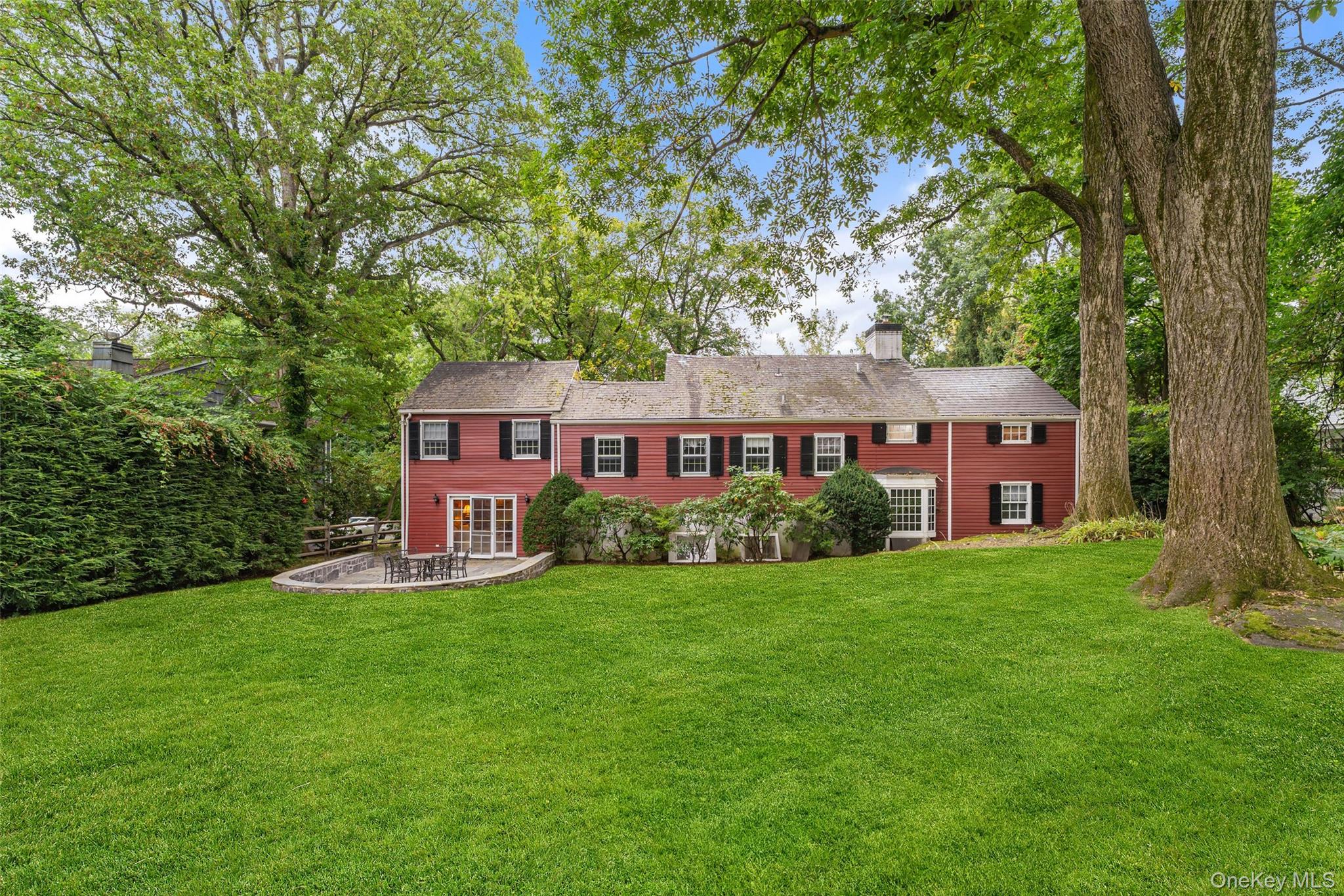 126 Penn Road Scarsdale, NY 10583 - Photo 28 of 34 a front view of a house with a yard and trees