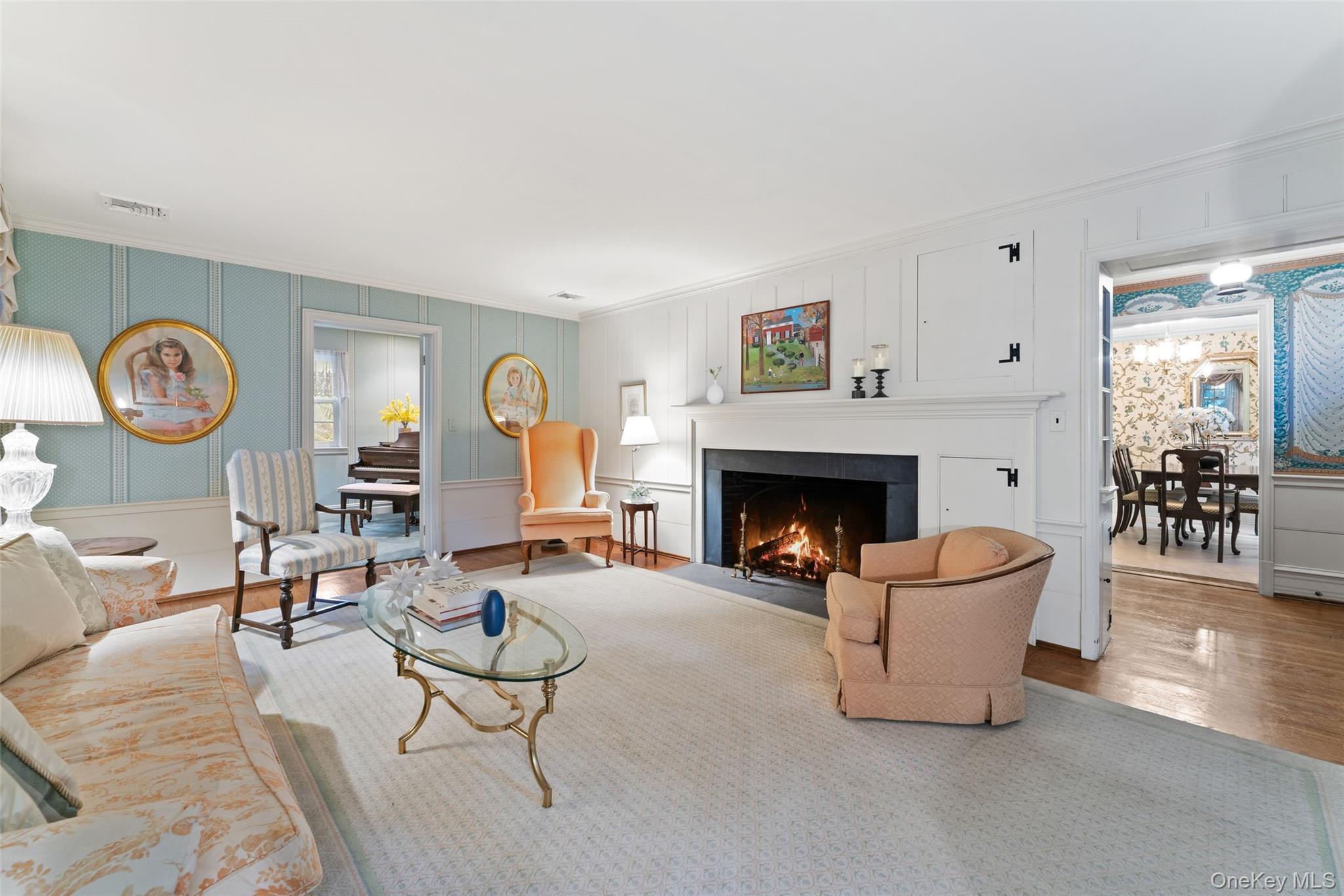 126 Penn Road Scarsdale, NY 10583 - Photo 4 of 34 a living room with furniture a clock and a fireplace
