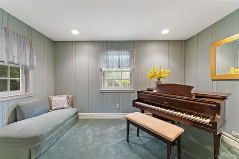 a living room with furniture and a piano