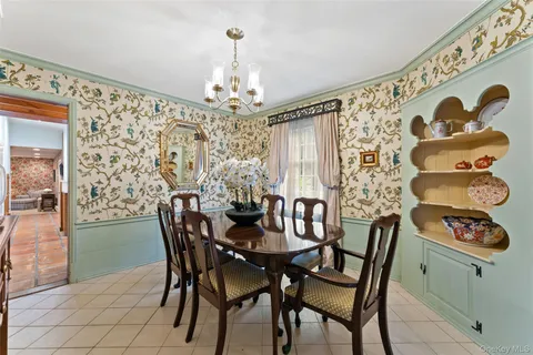 a view of a dining room with furniture and chandelier