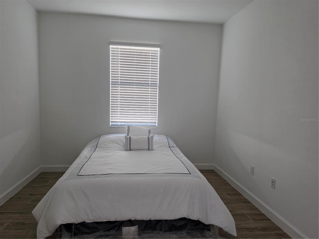 18334 Ridgeline Drive Estero, FL 33928 - Photo 14 of 30 a bedroom with a bed and a window