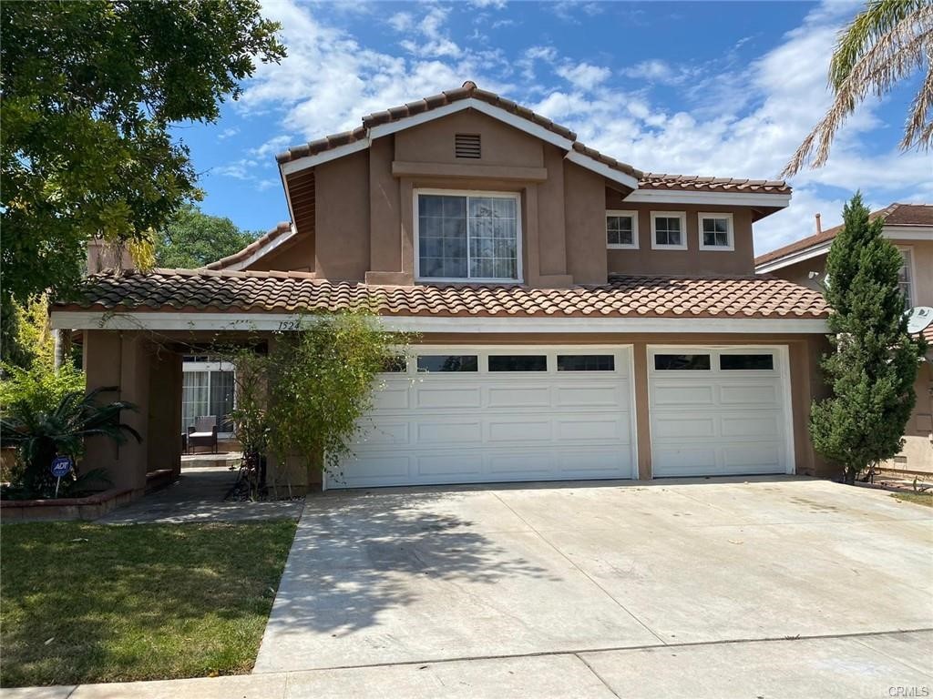 1524 Dominguez Ranch Road Corona, CA 92882 - Photo 1 of 1 a front view of a house with garden