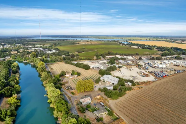 an aerial view of ocean and residential houses with outdoor space
