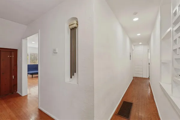 a view of residential houses with snow on the road