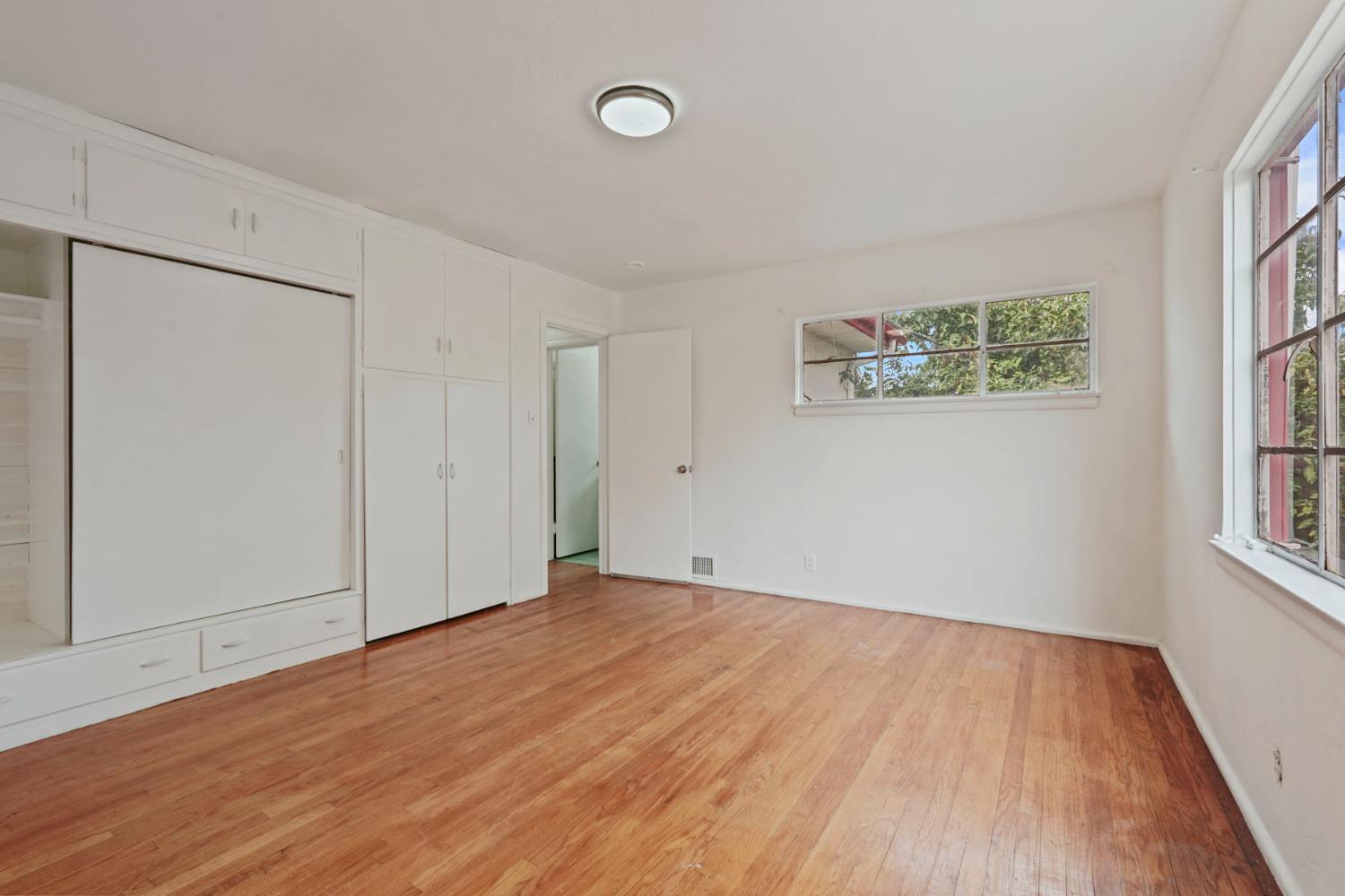 14371 Race Track Road Walnut Grove, CA 95690 - Photo 52 of 88 an empty room with wooden floor and windows