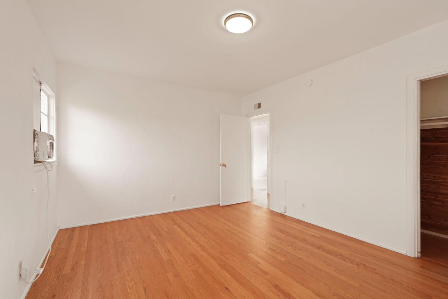 14371 Race Track Road Walnut Grove, CA 95690 - Photo 58 of 88 an empty room with wooden floor and windows