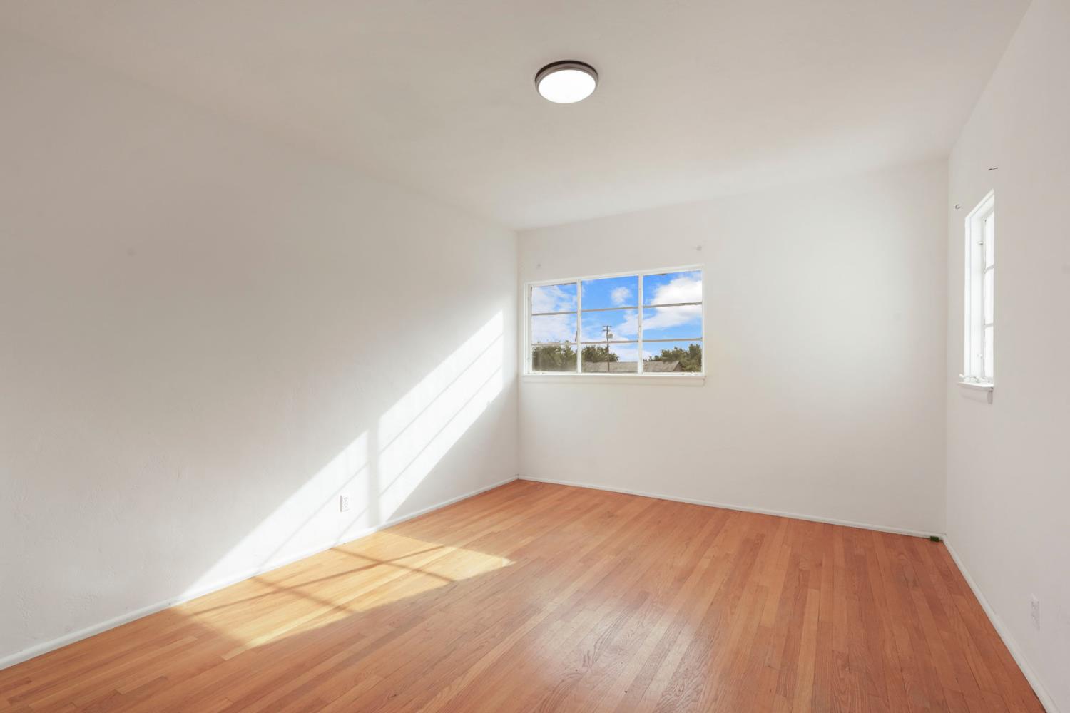14371 Race Track Road Walnut Grove, CA 95690 - Photo 59 of 88 an empty room with wooden floor and windows