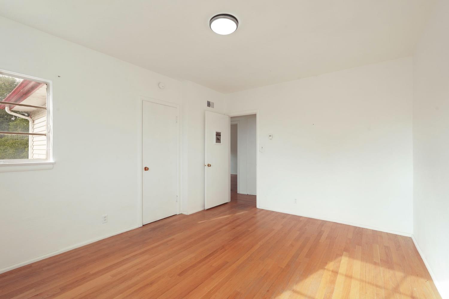 14371 Race Track Road Walnut Grove, CA 95690 - Photo 60 of 88 a view of empty room with wooden floor and fan