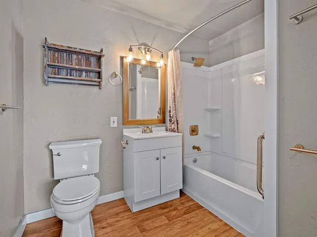 a bathroom with a sink toilet and shower