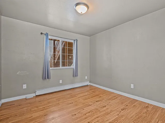 wooden floor and window in an empty room