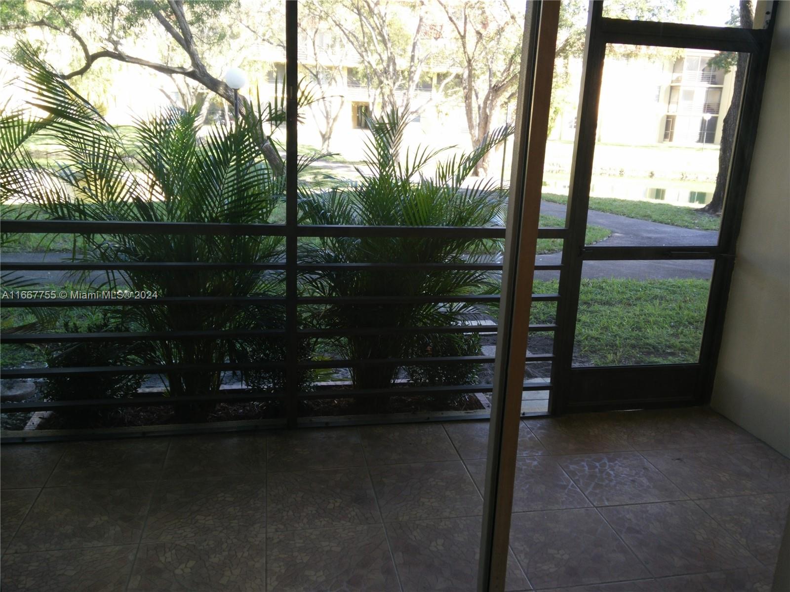 3285 Foxcroft Road, Unit E107 Miramar, FL 33025 - Photo 7 of 9 a view of outdoor space