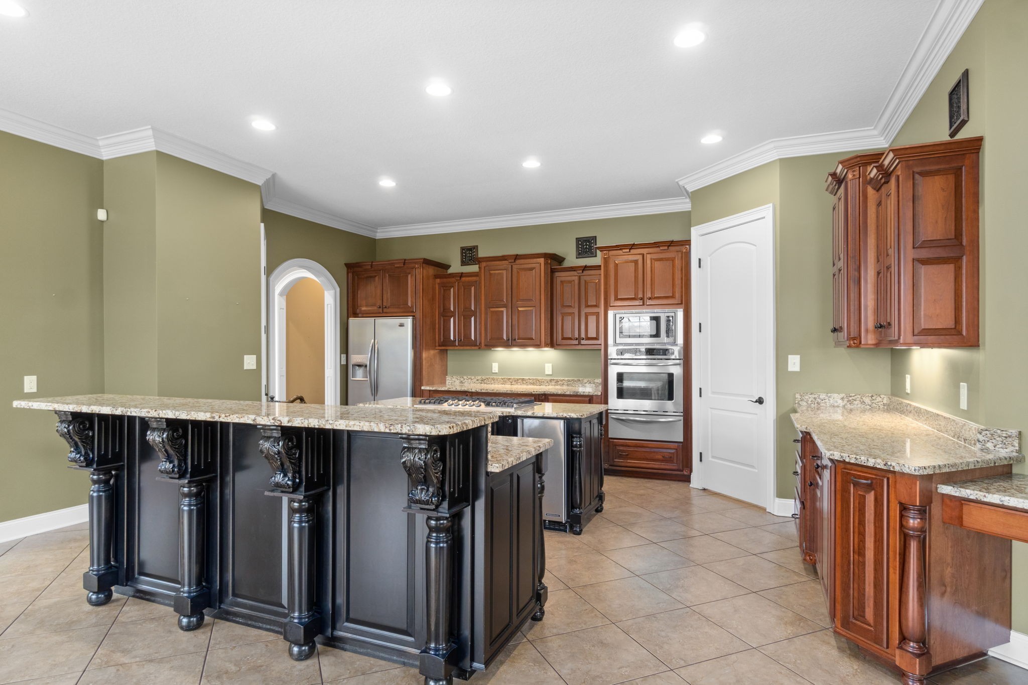 4591 Sango Road Clarksville, TN 37043 - Photo 17 of 70 a kitchen with stainless steel appliances granite countertop a sink a stove and a refrigerator