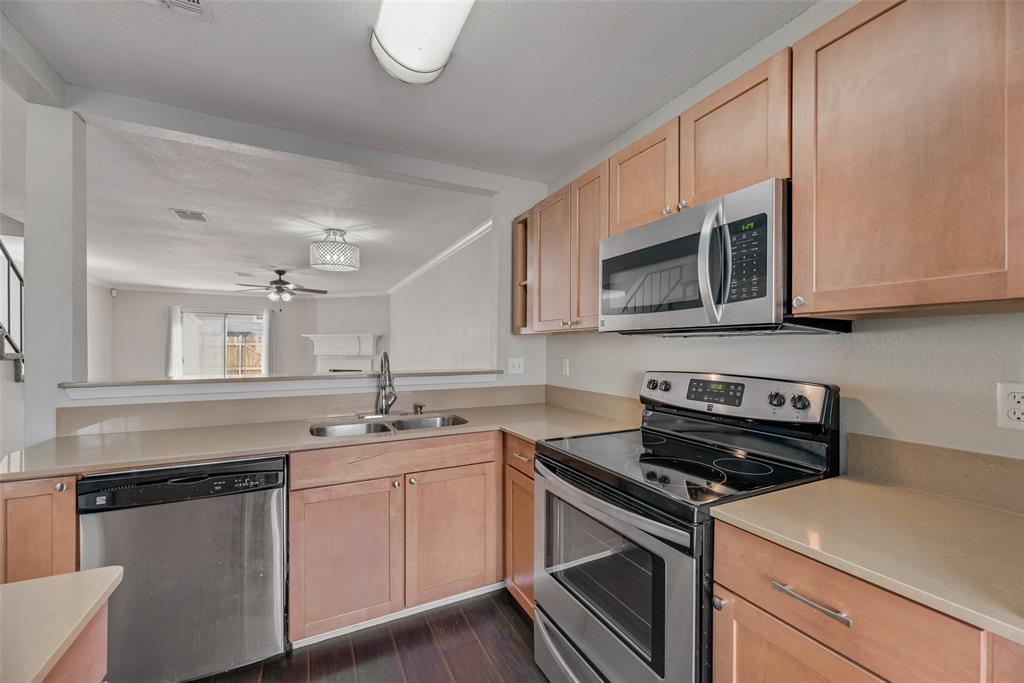 43 Abbey Road Euless, TX 76039 - Photo 13 of 22 a kitchen with stainless steel appliances granite countertop a sink a stove microwave and cabinets