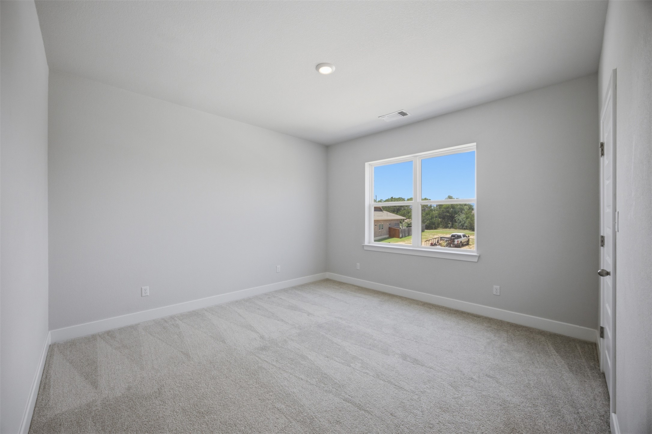 2101 Little Snake Way Georgetown, TX 78633 - Photo 27 of 37 A well-lit bedroom features plush carpeting and a generous window overlooking the neighborhood.