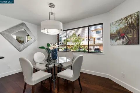 a dining room with furniture a rug and wooden floor