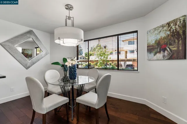 a dining room with furniture a rug and wooden floor