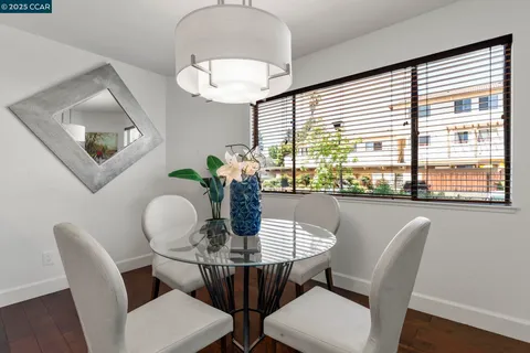 a kitchen with stainless steel appliances granite countertop a stove top oven a sink a refrigerator and white cabinets