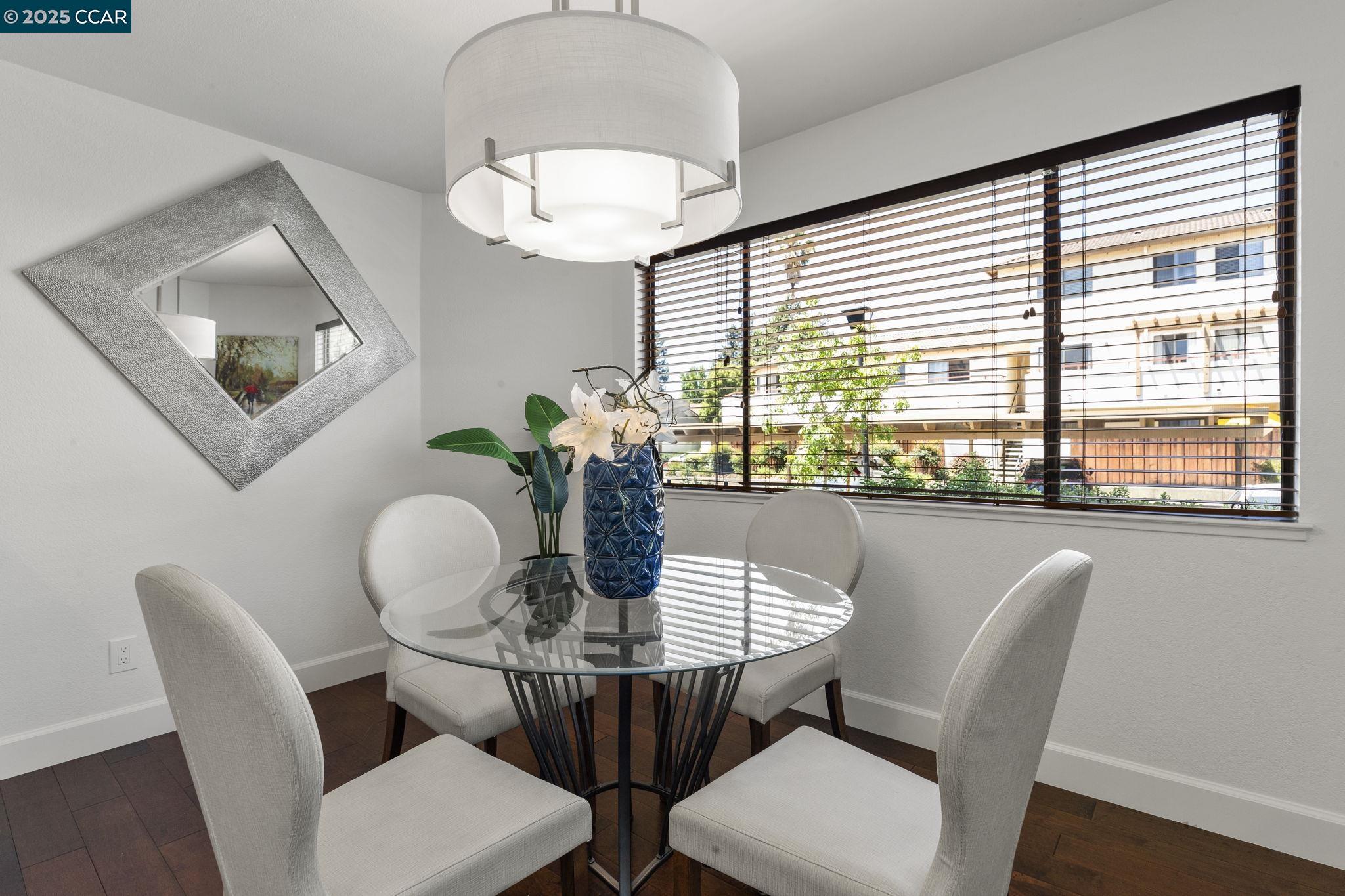 5050 Valley Crest Drive, Unit 63 Concord, CA 94521 - Photo 12 of 55 a dining room with furniture a rug and wooden floor