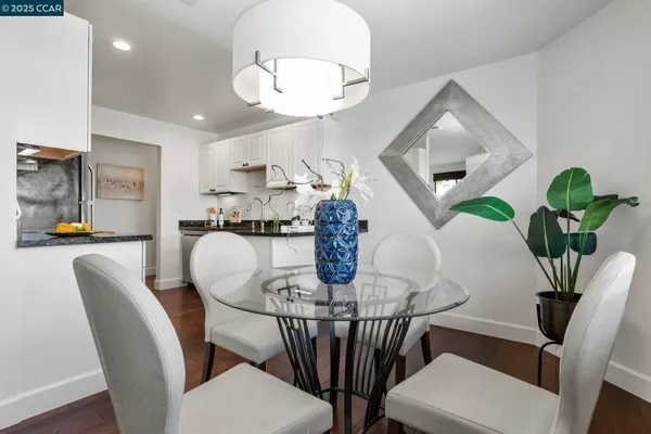 a kitchen with stainless steel appliances granite countertop a stove refrigerator sink and microwave