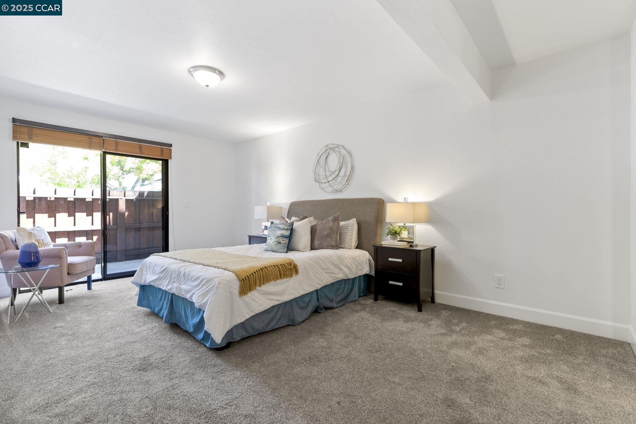 5050 Valley Crest Drive, Unit 63 Concord, CA 94521 - Photo 21 of 55 a spacious bedroom with a bed and a lamp with window