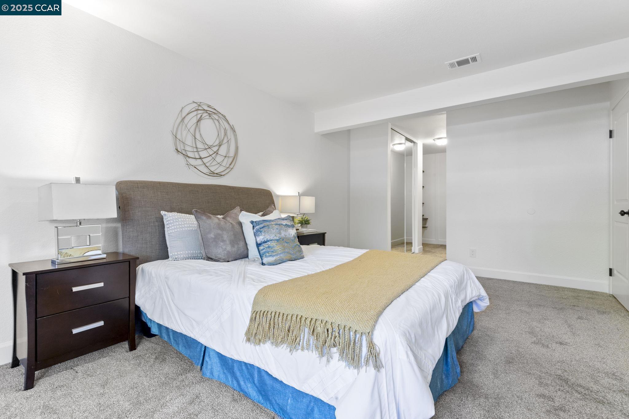 5050 Valley Crest Drive, Unit 63 Concord, CA 94521 - Photo 23 of 55 a bedroom with a bed and a chandelier