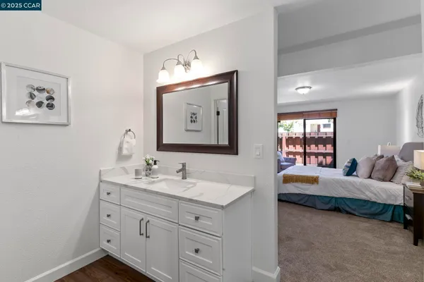 a bathroom with a sink vanity and a mirror