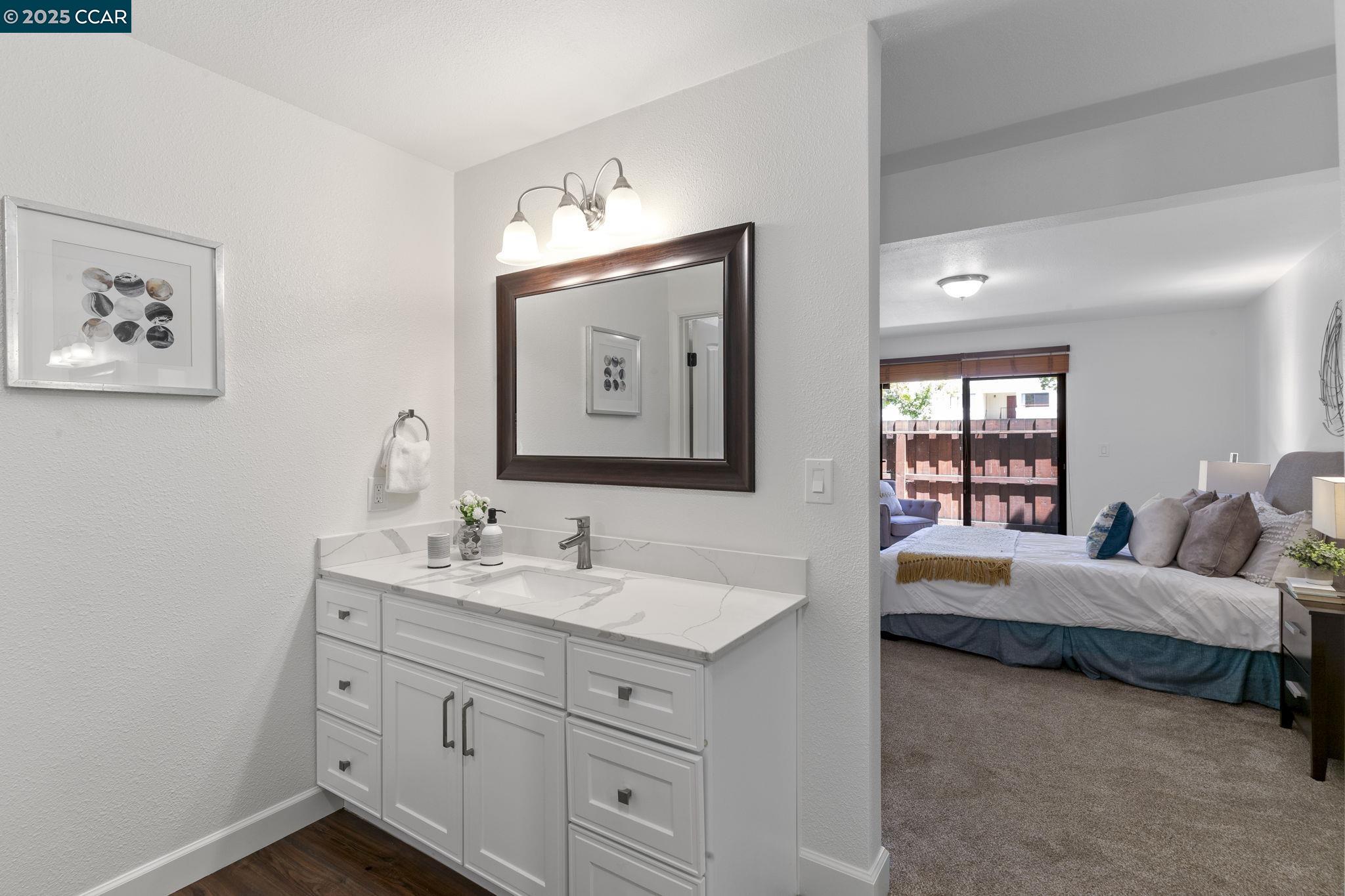 5050 Valley Crest Drive, Unit 63 Concord, CA 94521 - Photo 25 of 55 a en suite bathroom with double vanity sinks and a mirror