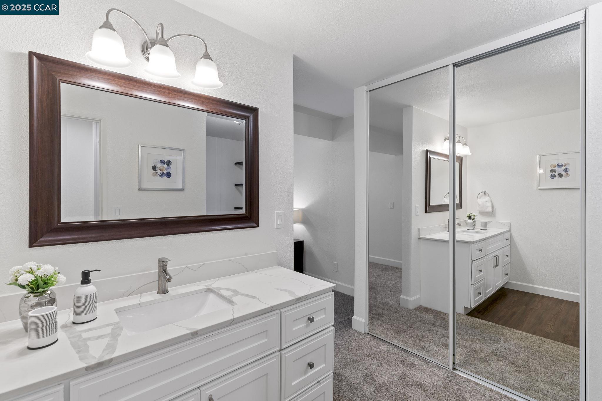 5050 Valley Crest Drive, Unit 63 Concord, CA 94521 - Photo 26 of 55 a bathroom with a sink and a mirror