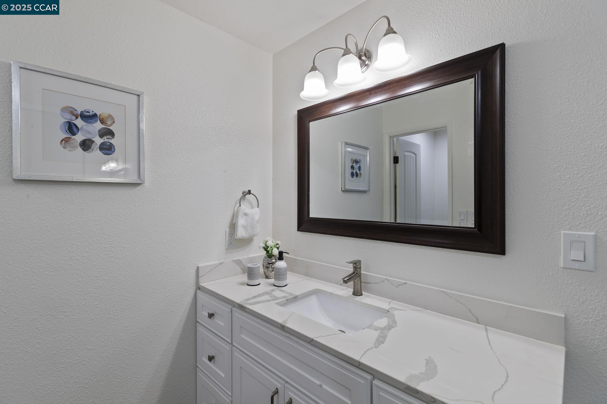 5050 Valley Crest Drive, Unit 63 Concord, CA 94521 - Photo 27 of 55 a bathroom with a sink vanity and a mirror