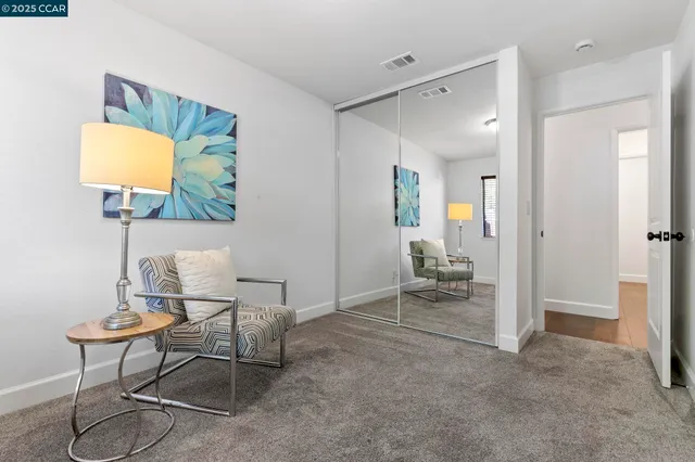 a living room with furniture and a lamp