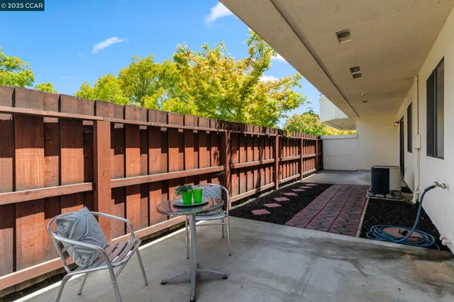 a view of a chairs and table in a patio