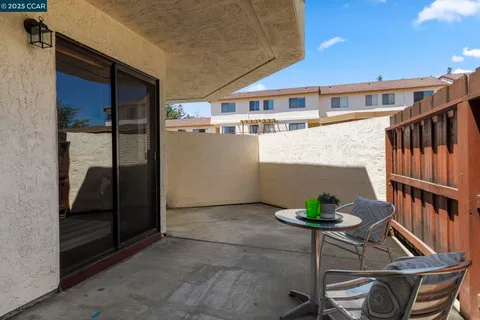 a view of a house with a yard and potted plants