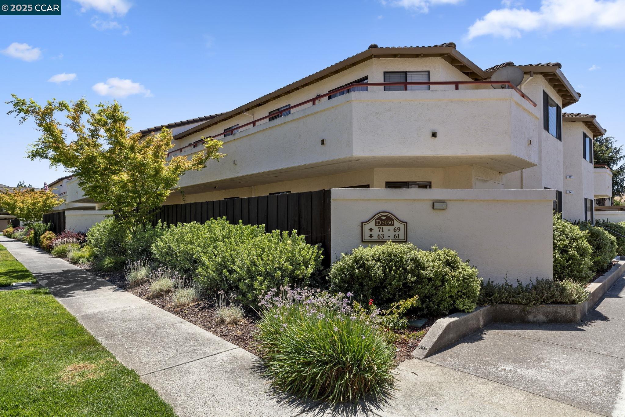 5050 Valley Crest Drive, Unit 63 Concord, CA 94521 - Photo 45 of 55 a front view of a house with a yard