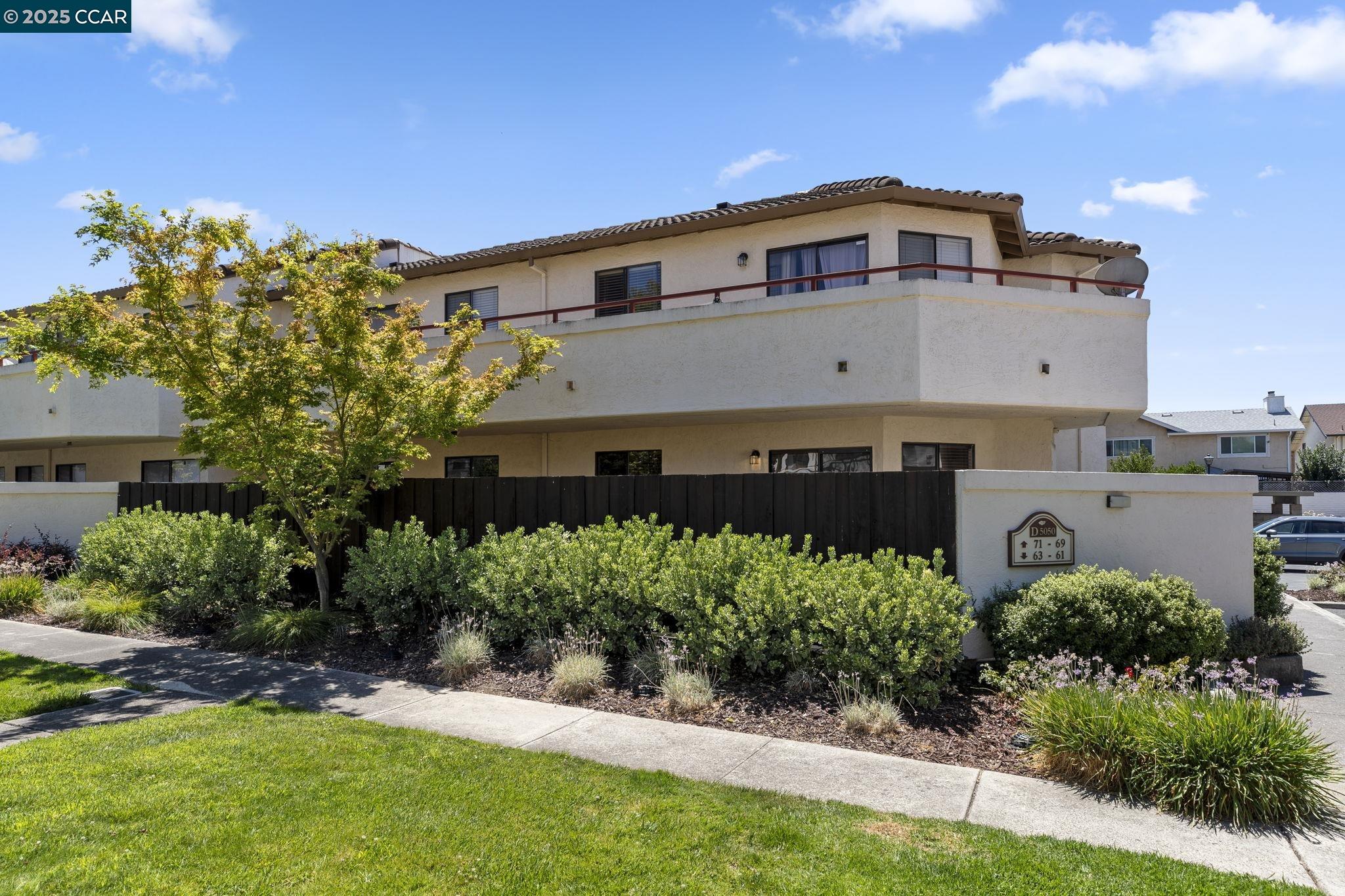 5050 Valley Crest Drive, Unit 63 Concord, CA 94521 - Photo 47 of 55 a front view of a house with a yard