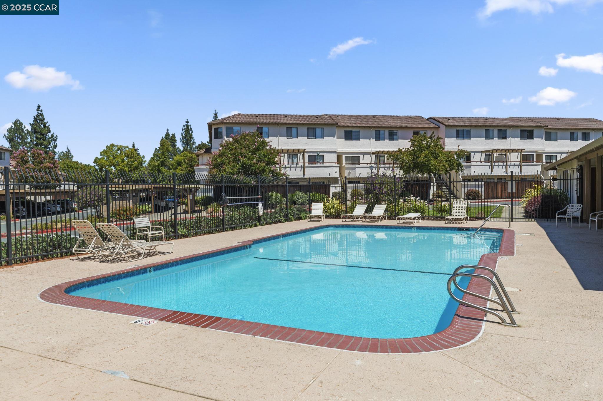 5050 Valley Crest Drive, Unit 63 Concord, CA 94521 - Photo 55 of 55 a view of a swimming pool with outdoor seating
