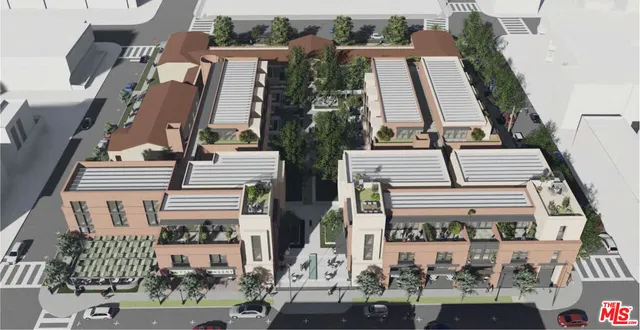 an aerial view of a residential apartment building with a yard