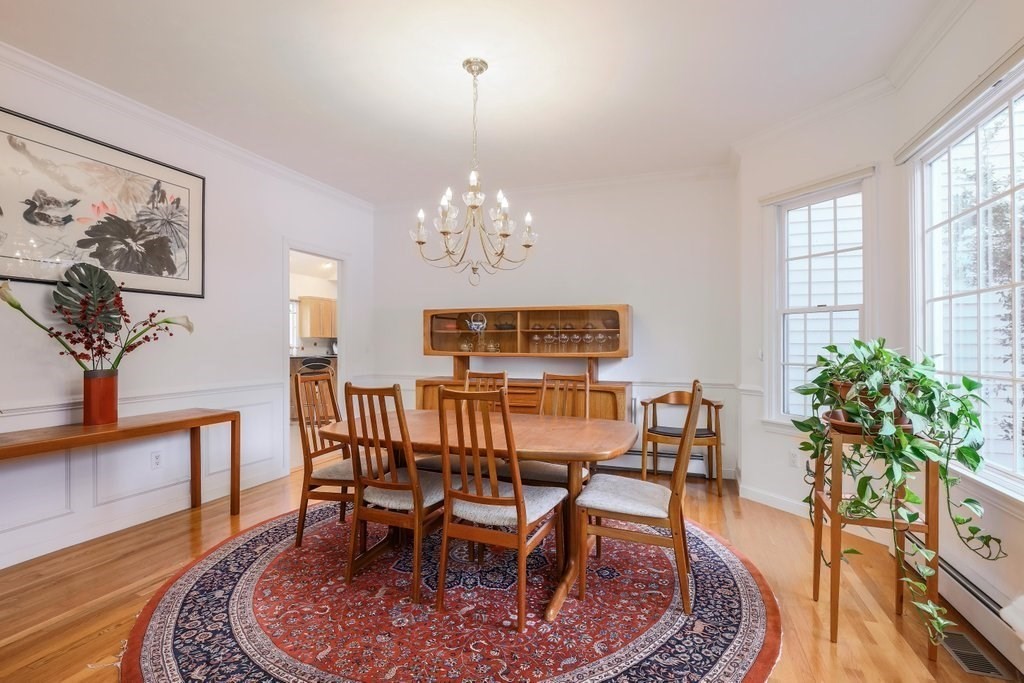 16 Steel Road Hopedale, MA 01747 - Photo 11 of 42 a view of a dining room with furniture a chandelier and wooden floor