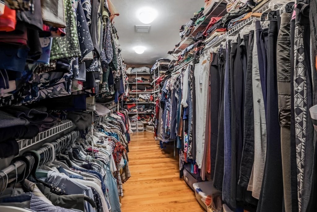 16 Steel Road Hopedale, MA 01747 - Photo 22 of 42 a view of walk in closet with clothes and shoes