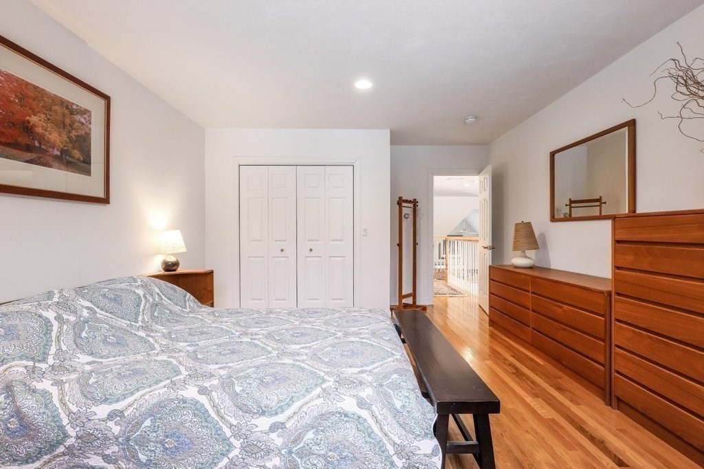 16 Steel Road Hopedale, MA 01747 - Photo 26 of 42 a bedroom with a bed and a chandelier